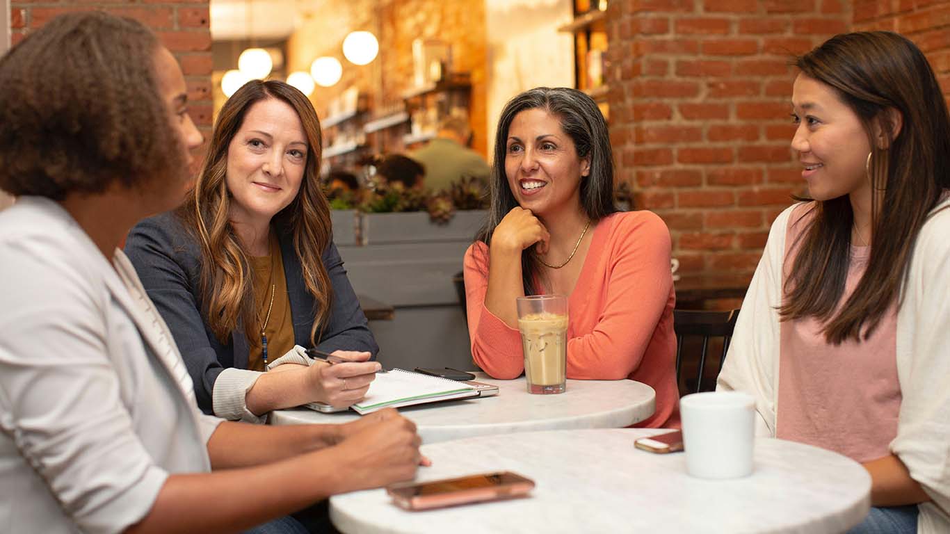 Four women working in a business meeting